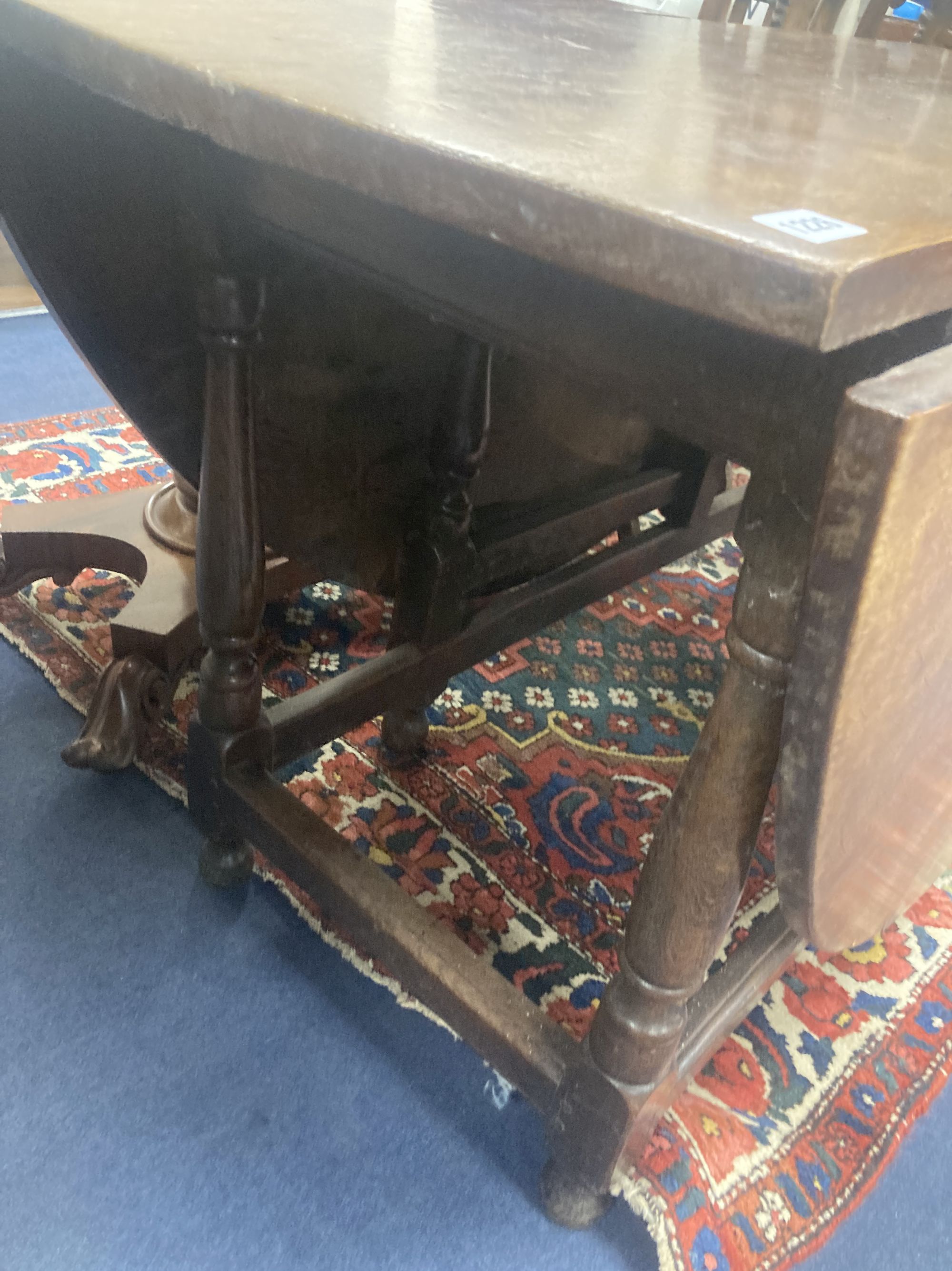 An 18th century oak gateleg dining table, width 173cm, depth 142cm, height 76cm